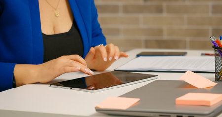 Woman hands working from home on tablet answering to clients. Business Woman concerned in data results monthly using technology.の写真素材