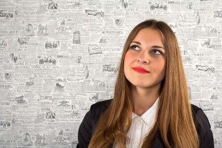 Thinking businesswoman portrait close up on the background paper wallpaper