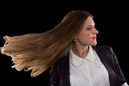 Businesswoman with beautiful hear isolated on blackの写真素材