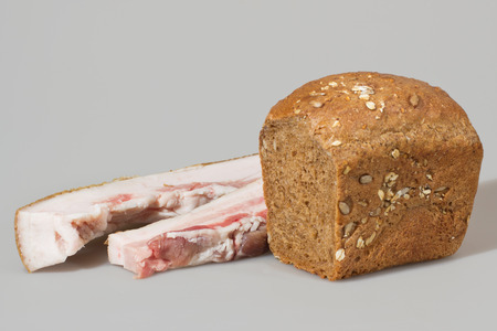 Lard with rye bread in the seeds on a gray background