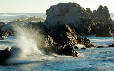 Waves crashing on rocks on coastline of central California, Pacific Grove, USAの写真素材
