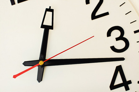 Close-up white dial watch with red second hand