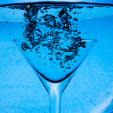 underwater air bubbles in wineglassの写真素材