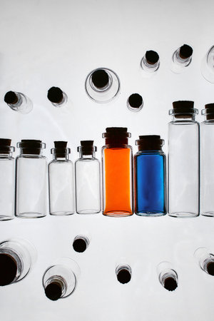 Full glass bottles among emptyの写真素材