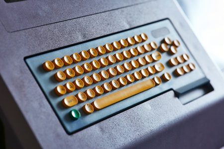 Built-in color keyboard with yellow mechanical buttons for the computer of a large industrial knitting machineの写真素材