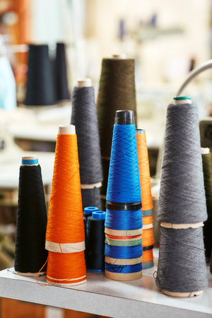 A few almost used bobbins with knitting threadsの写真素材