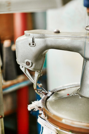 A small simple knitting machine with threads nearby without workersの写真素材