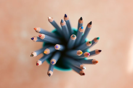 many sharpened colored pencils in a tube top view