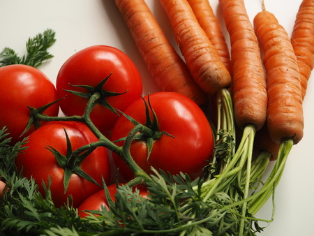 Tomatoes and carrots close-upの写真素材