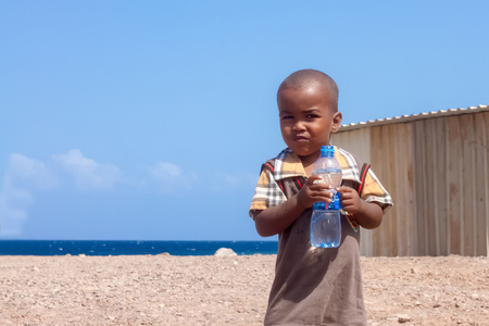 Cute African Child with Water Bottle Drink holding in his handsのeditorial素材