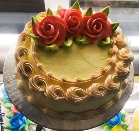 Birthday or celebration cake displayed and decorated flower on the top in a cake shop at Bagdogra,...