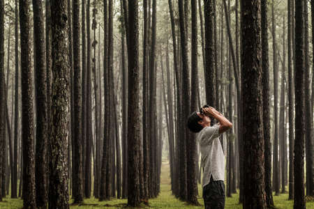 A tourist man take photo in Pine Forest