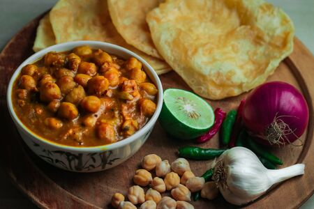 Chole Bhture or Chana masala is a Famous Indian dish originated initially from eastern Uttar Pradesh in the northern part of the Indian subcontinent.の写真素材