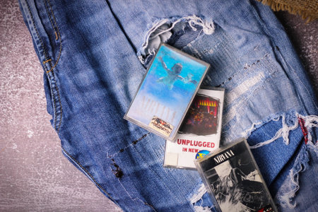 WASHINGTON, USA - September 30 2022 : Nirvana's cassette tape and Ripped jeans or Torn jeans. A symbol of the grunge or Seattle sound.のeditorial素材
