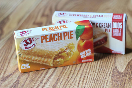 Seattle, USA - April 07 2022 : JJ's bakery's peach pie, strawberry and cream pie on a wooden table, pie as a snack. popular in americaのeditorial素材