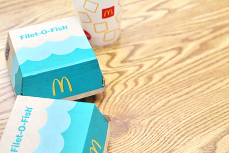 SEATTLE, USA - April 07 2022 : The McDonald's fish burger known as filet-o-fish served on a wooden...