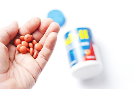 Washington, USA - October 02  2022 : Bottles of advil and pills spread on a white table. Fever, painkiller, popular American painkiller, ibuprofen.のeditorial素材