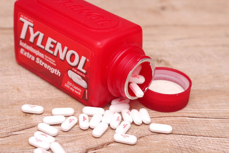 WASHINGTON, USA - October 15, 2022: Bottle Of Tylenol Extra Strength With Many Pills On A Wooden Table Which Was Sold Out During Covid-19 time, headache, Painkillers.のeditorial素材