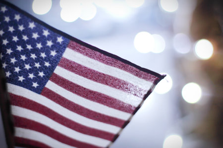 American flag with white light blur background.