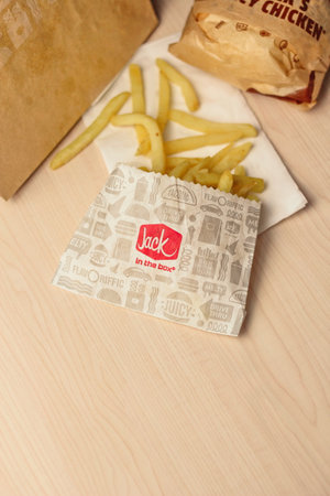 WASHINGTON, USA - January 10, 2023 : A home-style rance chiken club burger or Jack Spicy Chicken Burger served on a wooden table in a jack in the box restaurant in the USA.のeditorial素材