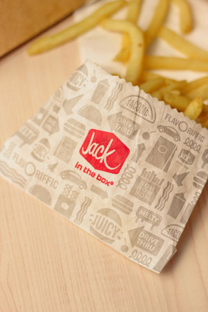 WASHINGTON, USA - January 10, 2023 : A home-style rance chiken club burger or Jack Spicy Chicken Burger served on a wooden table in a jack in the box restaurant in the USA.のeditorial素材