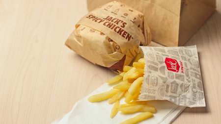 WASHINGTON, USA - January 10, 2023 : A home-style rance chiken club burger or Jack Spicy Chicken Burger served on a wooden table in a jack in the box restaurant in the USA.のeditorial素材