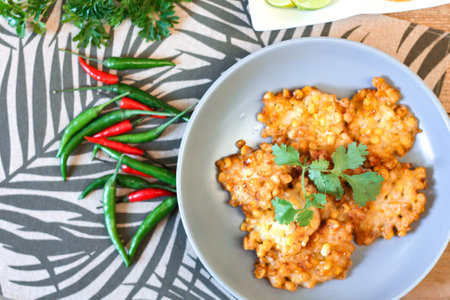 Corn Fritters With chili sauce placed on a wooden table