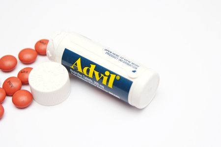 Advil painkillers, portable pill bottles, American popular painkillers, white background.