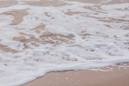 Bubbles on golden beach with ocean water in the morning at Thailand beaches.の写真素材