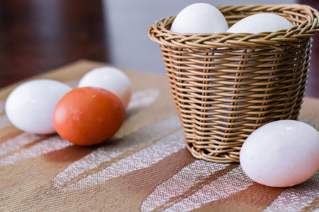 1 chicken egg and several duck eggs on the table.