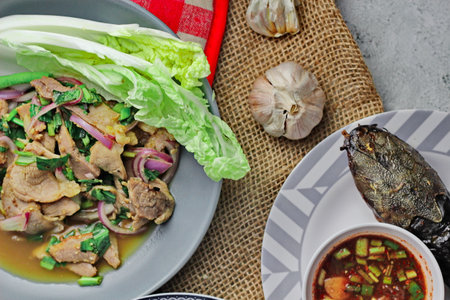 Delicious Thai food on the table in a restaurant in Thailand, papaya salad, larb, waterfall, sticky rice. top view, layout, flatlayの写真素材