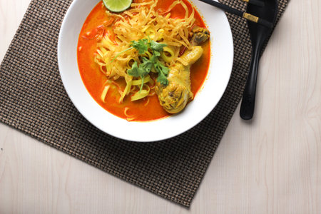 Khao Soi or Spicy Khao Soi is a popular Thai food, top view, flat layの写真素材