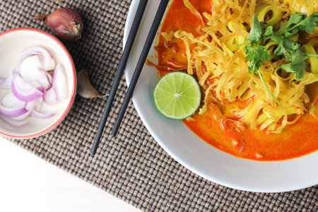 Khao Soi or Spicy Khao Soi is a popular Thai food, top view, flat layの写真素材