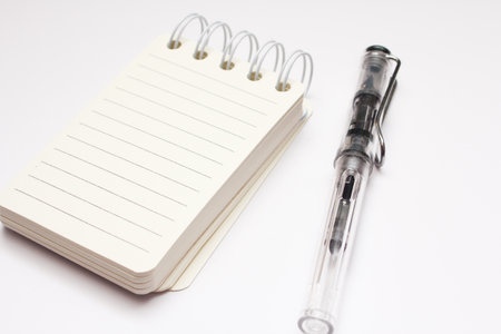 notebook and pen isolated on white background, closeup of photo