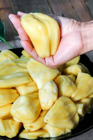 Thai fruit, fresh jackfruit placed in a black plate on a wooden table.の写真素材