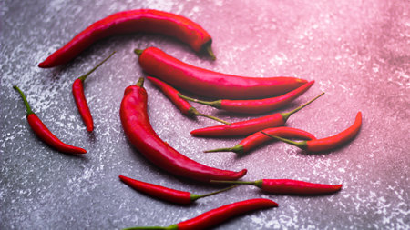 Red chilli and green chilli, garlic spread on the gray table ready to cook in the kitchen.