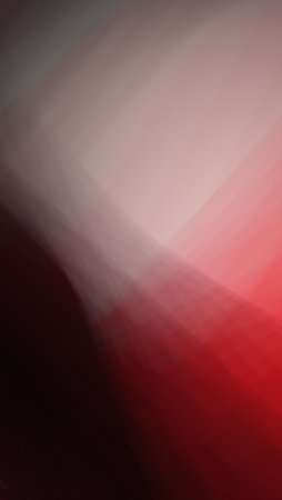 A striking blend of red and pink hues creates a seamless gradient with soft transitions. The vivid colors merge fluidly, forming a dynamic and visually captivating abstract composition.の写真素材