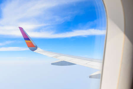 Clouds and sky as seen through window of an aircraftの写真素材