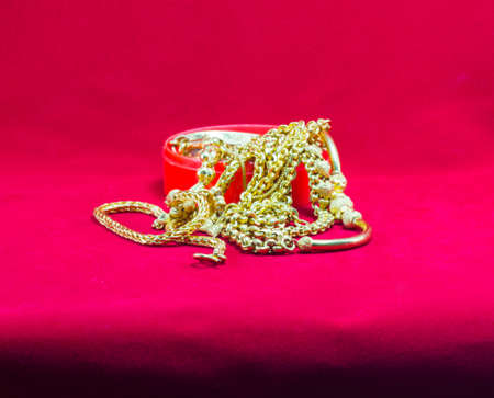 gold necklace red backgroundの写真素材