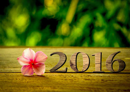 Sigh symbol from number 2016 on old retro vintage style wooden texture backgroundの写真素材