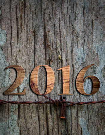 Sigh symbol from number 2016 on old retro vintage style wooden texture backgroundの写真素材