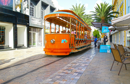 Oranjestad, Aruba - Oct 15, 2018.  Tourist boarding and riding on Free City Trolley / Street Car.  Hop on Hop Off in the tourist area.のeditorial素材
