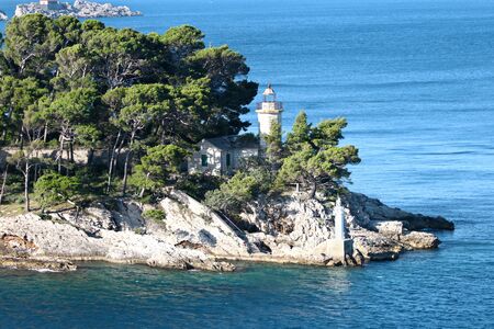 Dubrovnik, Croatia. Seascape view of turquoise waters of Adriatic Sea and island.  Lighthouse at entrance to Dubrovnik inner harbourのeditorial素材