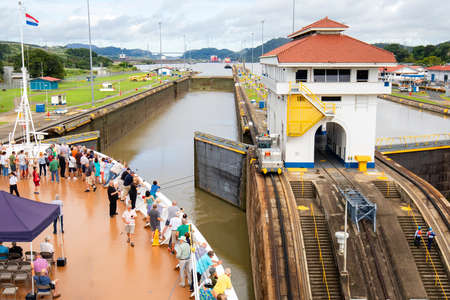 Panama Canal, Panama - Oct 13, 2018: Cruise ship Approaching 
opened gates of Miraflores Lock. This is the narrower Original historic Panama Canal, Panama.  Cruise ship tourists on Bow of ship.のeditorial素材