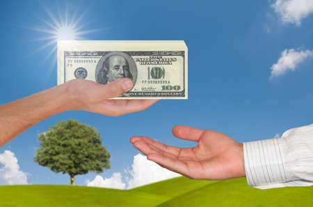 Hand giving 100 dollar to another hand
