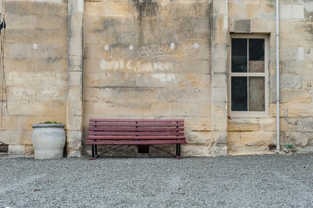 Historic building with red benchの写真素材