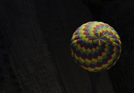 Colorful hot-air balloons flying over the farmの写真素材
