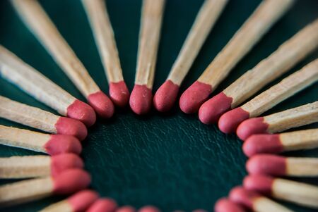 Close-up of wooded matchsticks on dark background.の写真素材