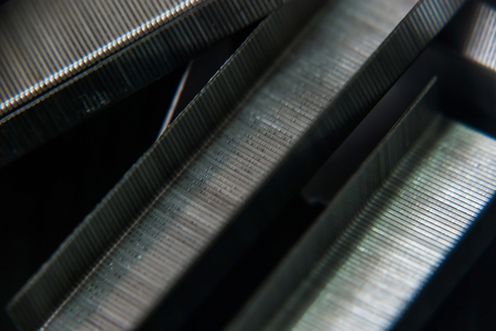 Close-up stapler and staple is isolated on a black background.の写真素材