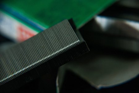 Close-up stapler and staple is isolated on a black background.の写真素材